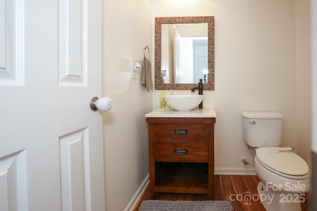 bathroom with vanity, hardwood / wood-style floors, and toilet