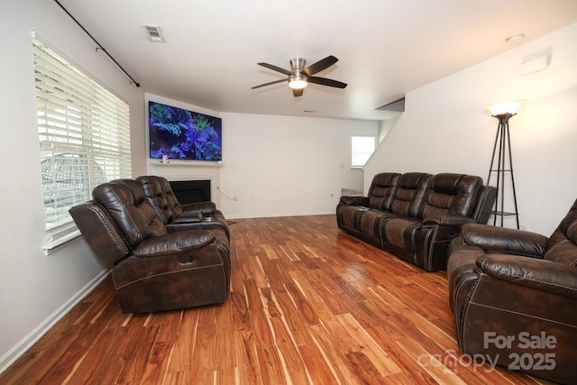 living room with hardwood / wood-style floors and ceiling fan