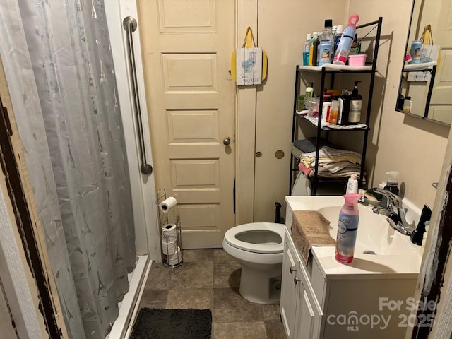 bathroom featuring vanity, toilet, and curtained shower