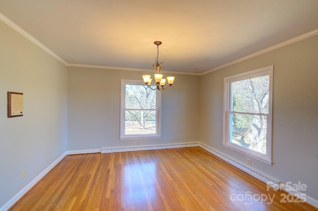 empty room with a baseboard heating unit, ornamental molding, a chandelier, and light wood-type flooring