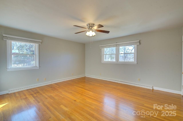 unfurnished room featuring a baseboard radiator, ceiling fan, and light hardwood / wood-style floors