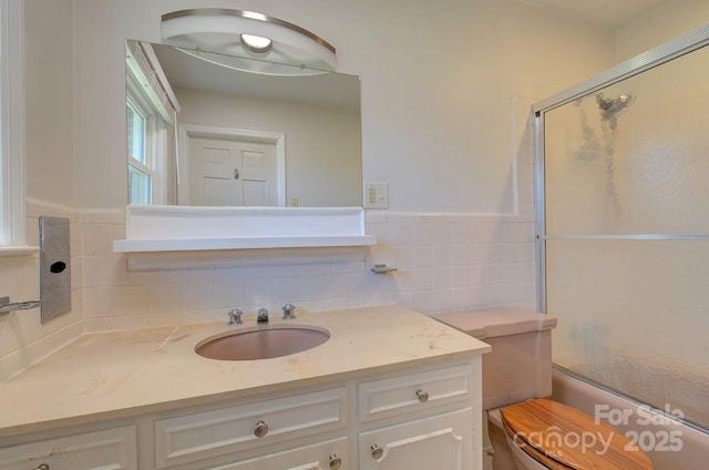 bathroom featuring vanity, tile walls, and walk in shower