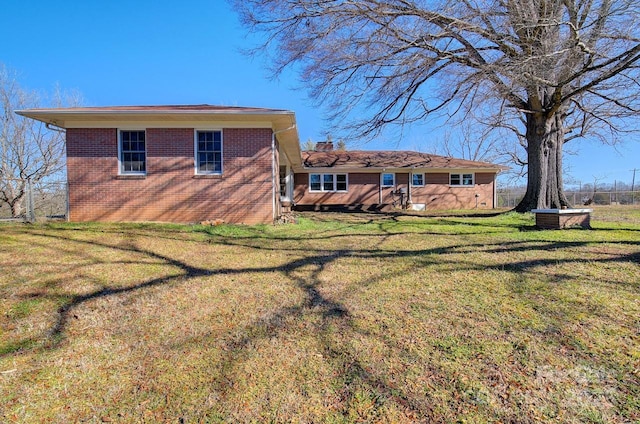 back of property featuring a lawn