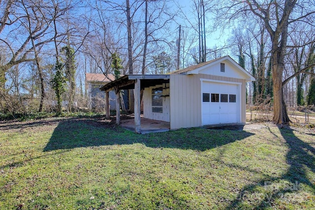 view of outbuilding featuring a garage and a yard