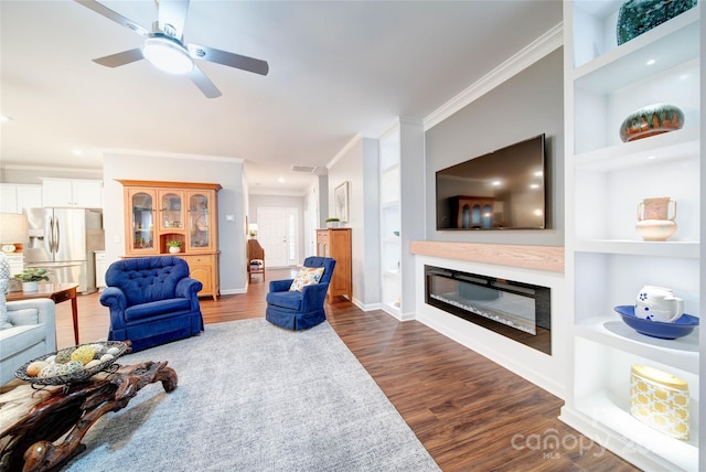 living room featuring ornamental molding, dark wood-type flooring, and built in features