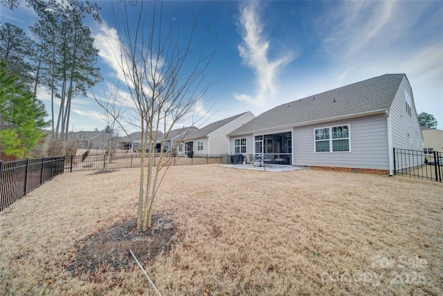 back of property featuring a yard and a patio