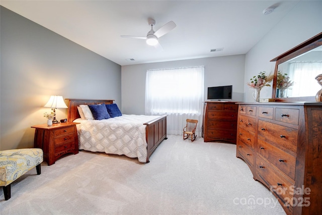 bedroom with light carpet and ceiling fan