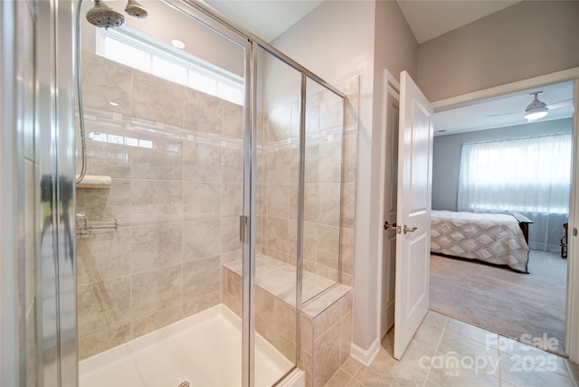 bathroom with tile patterned flooring, a healthy amount of sunlight, and a shower with shower door