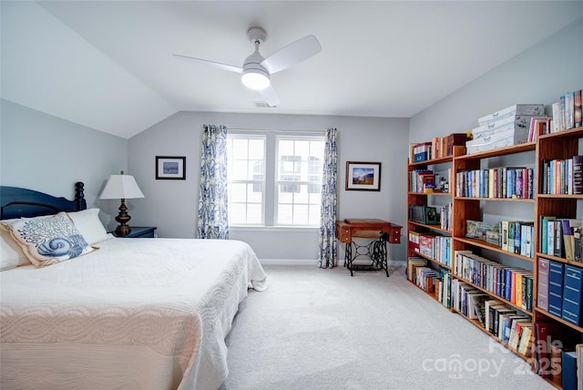 bedroom with vaulted ceiling, ceiling fan, and carpet floors