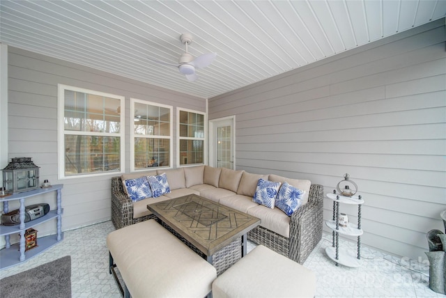 sunroom / solarium featuring ceiling fan