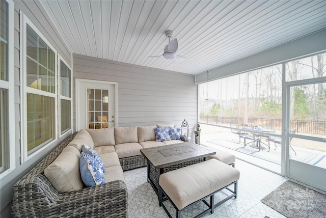 sunroom with plenty of natural light and ceiling fan