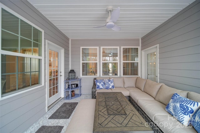 sunroom featuring ceiling fan