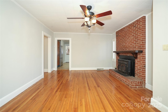 unfurnished living room with crown molding, ceiling fan, and light wood-type flooring