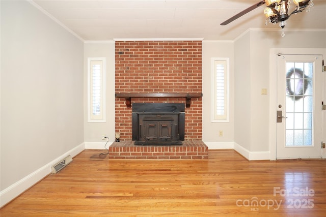 unfurnished living room with crown molding, wood-type flooring, and a wealth of natural light