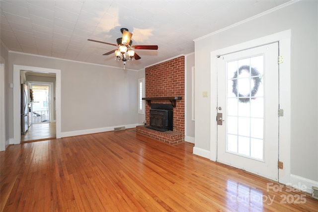 unfurnished living room featuring crown molding, ceiling fan, and light wood-type flooring