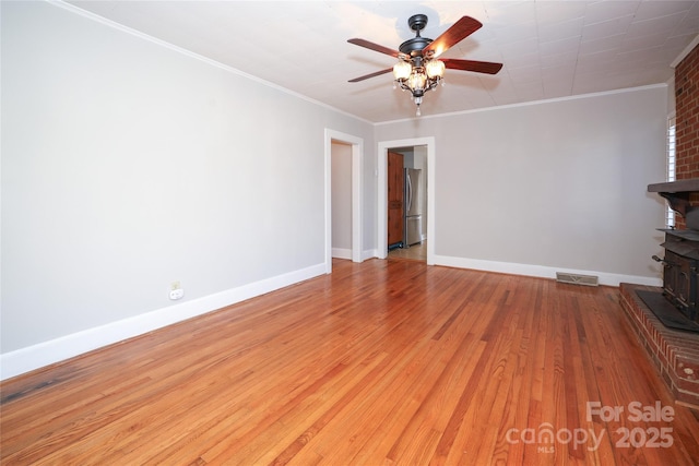 unfurnished living room with ceiling fan, ornamental molding, and light hardwood / wood-style flooring