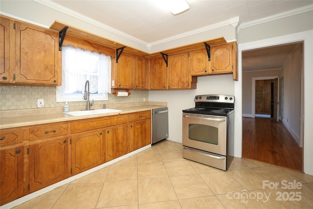 kitchen with sink, crown molding, light tile patterned floors, backsplash, and stainless steel appliances