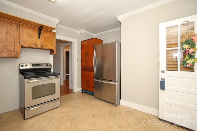 kitchen with ornamental molding, stainless steel appliances, and light tile patterned flooring