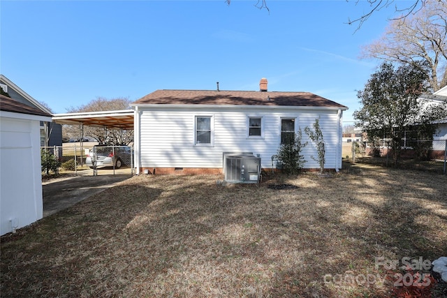 rear view of house with a carport, a lawn, and central air condition unit