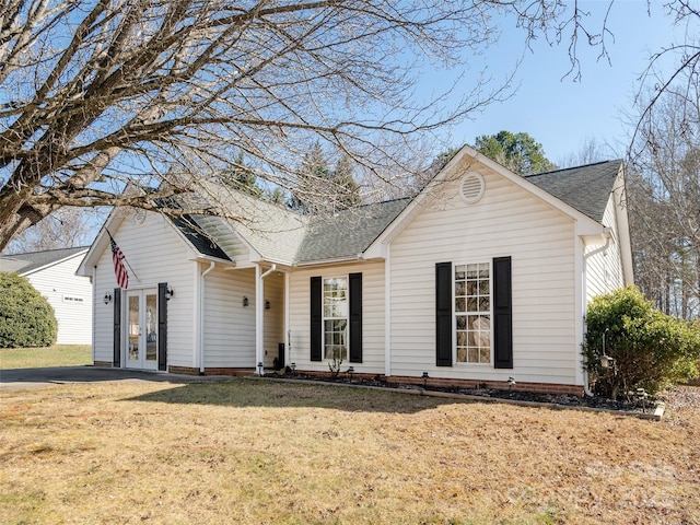 view of front of home with a front lawn and french doors