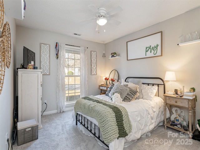 carpeted bedroom featuring visible vents, ceiling fan, and baseboards