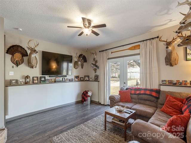 living room with dark hardwood / wood-style flooring, ceiling fan, french doors, and a textured ceiling