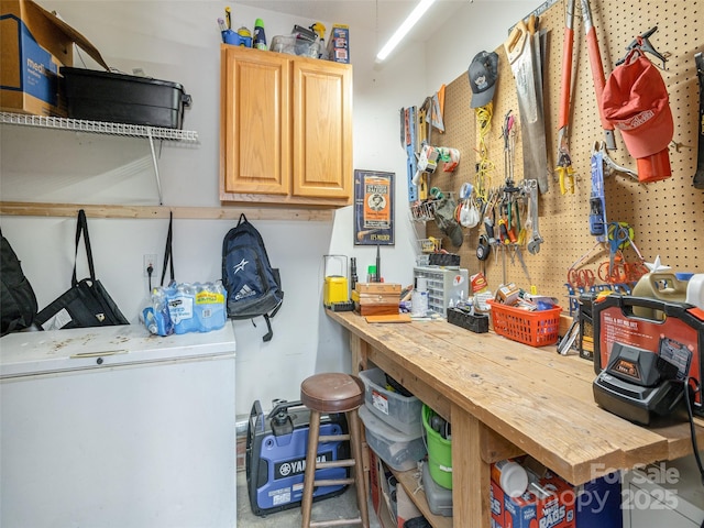 interior space with light brown cabinetry, fridge, and wood counters