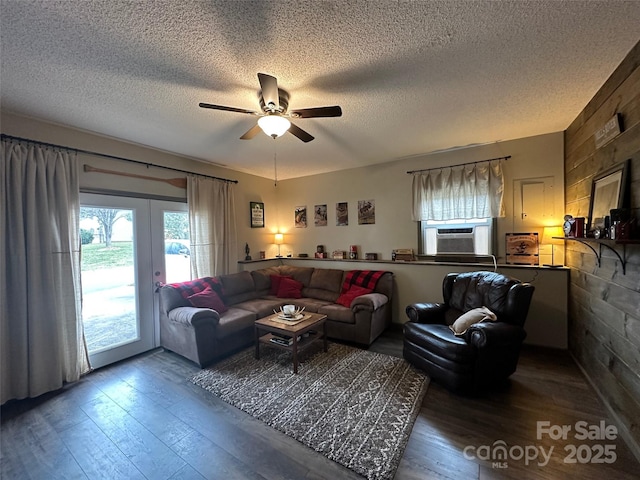 living area with cooling unit, a textured ceiling, and hardwood / wood-style floors