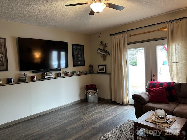 living room with a textured ceiling, wood finished floors, and french doors