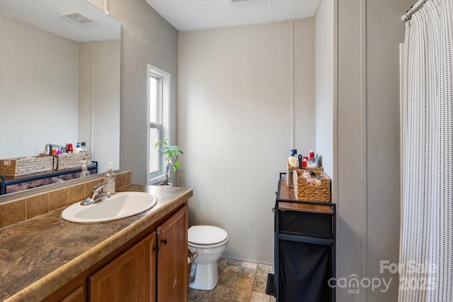 bathroom with vanity and toilet