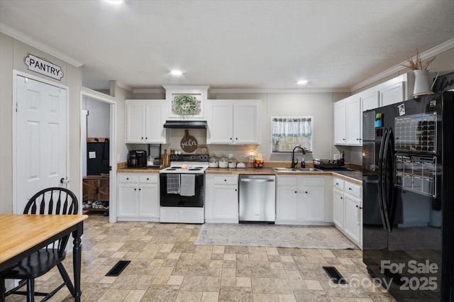 kitchen with electric stove, sink, dishwasher, black refrigerator, and white cabinets