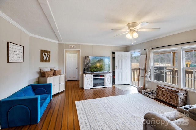 living room featuring crown molding, ceiling fan, and wood-type flooring