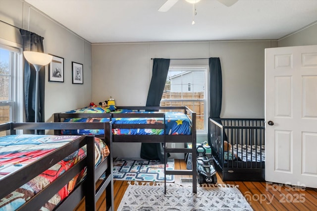 bedroom with ceiling fan and dark hardwood / wood-style flooring