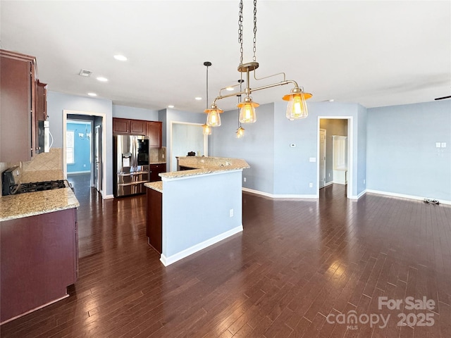 kitchen with backsplash, stainless steel appliances, dark hardwood / wood-style floors, a center island, and decorative light fixtures