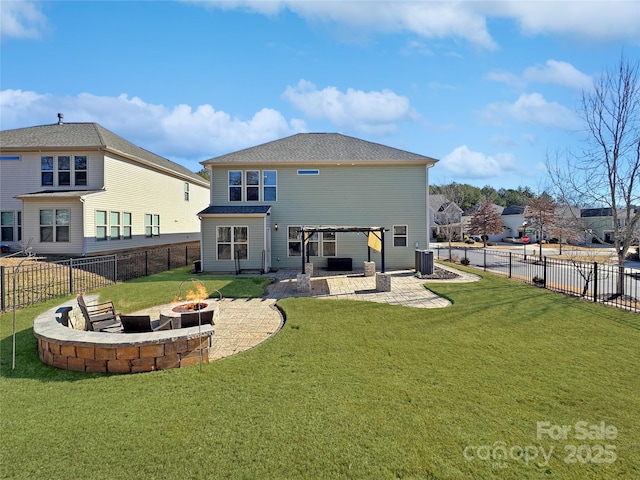 back of house with cooling unit, an outdoor fire pit, a patio, and a lawn