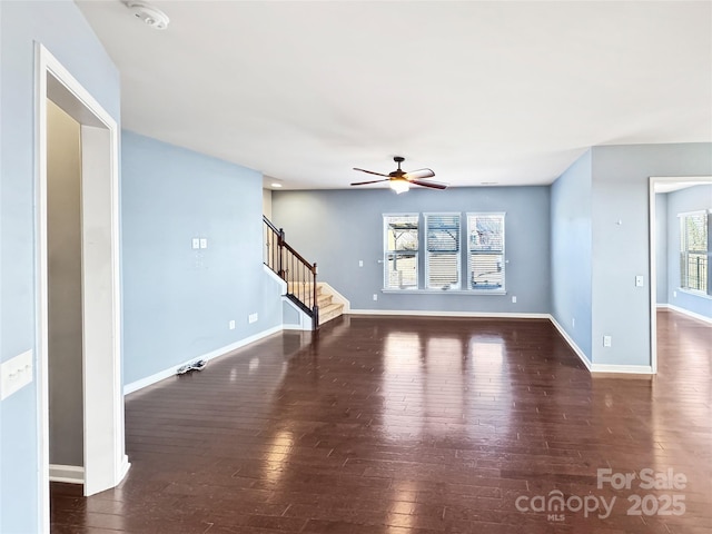 unfurnished living room featuring ceiling fan and dark hardwood / wood-style floors