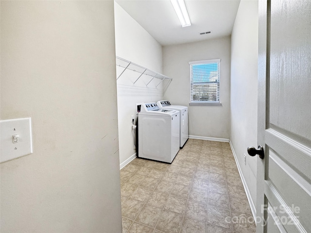 clothes washing area with independent washer and dryer