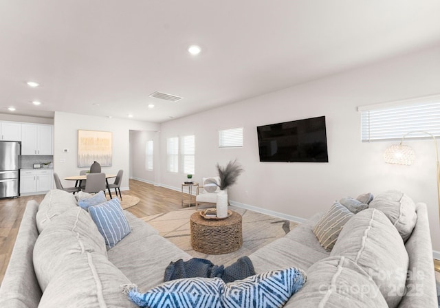 living room with light hardwood / wood-style floors