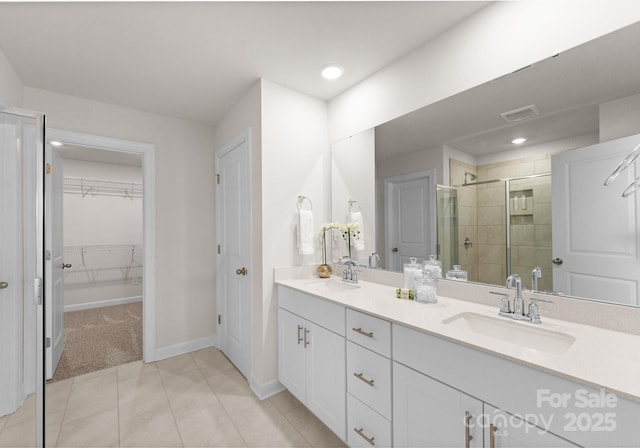 bathroom featuring tile patterned floors, vanity, and an enclosed shower