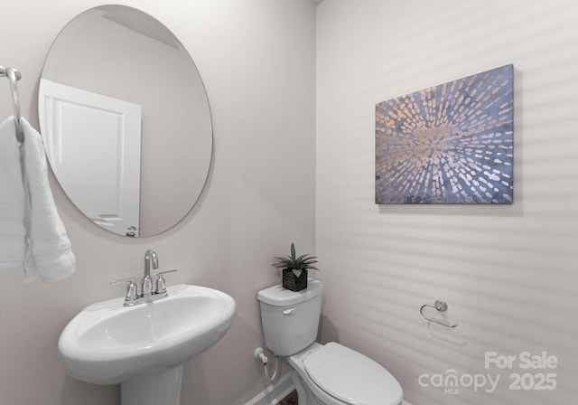 bathroom featuring sink and toilet