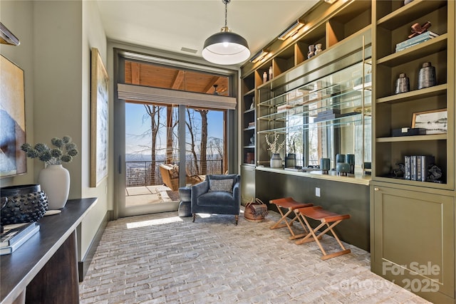 sitting room featuring brick floor