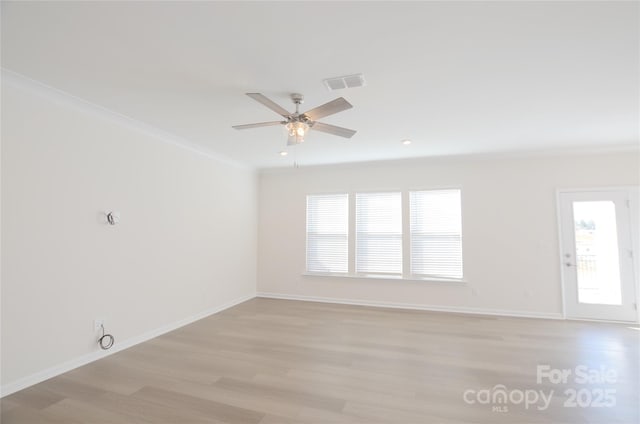 empty room featuring crown molding, ceiling fan, and light hardwood / wood-style flooring