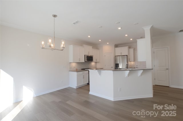 kitchen with crown molding, stainless steel appliances, light hardwood / wood-style floors, and white cabinets