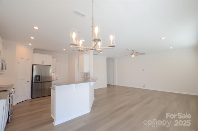 kitchen with electric stove, light hardwood / wood-style floors, white cabinets, stainless steel fridge with ice dispenser, and kitchen peninsula