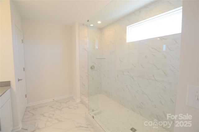 bathroom featuring vanity and tiled shower