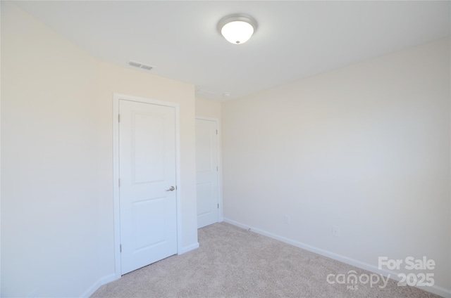 spare room with light colored carpet