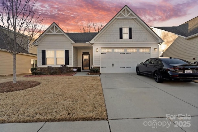 view of front of house with a garage and a yard