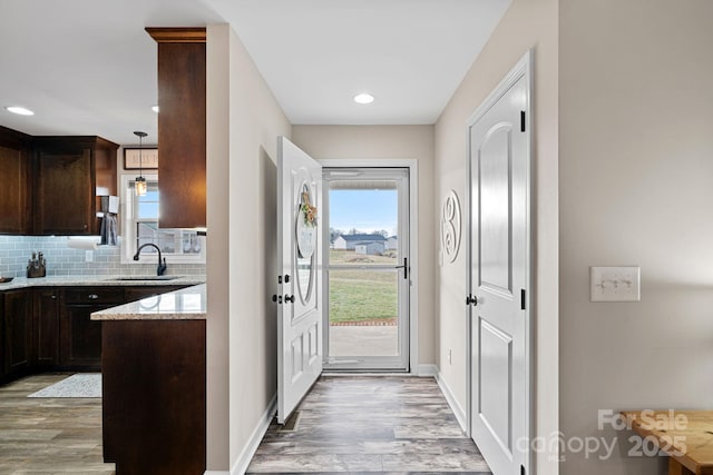 entryway featuring sink and light hardwood / wood-style floors