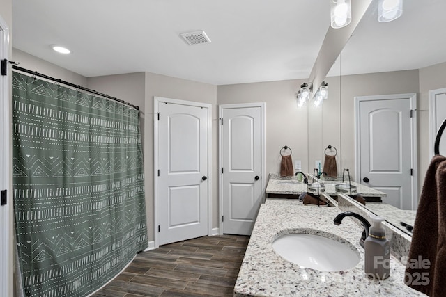 bathroom with vanity, hardwood / wood-style floors, and curtained shower