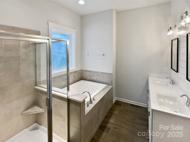 bathroom featuring vanity and shower with separate bathtub